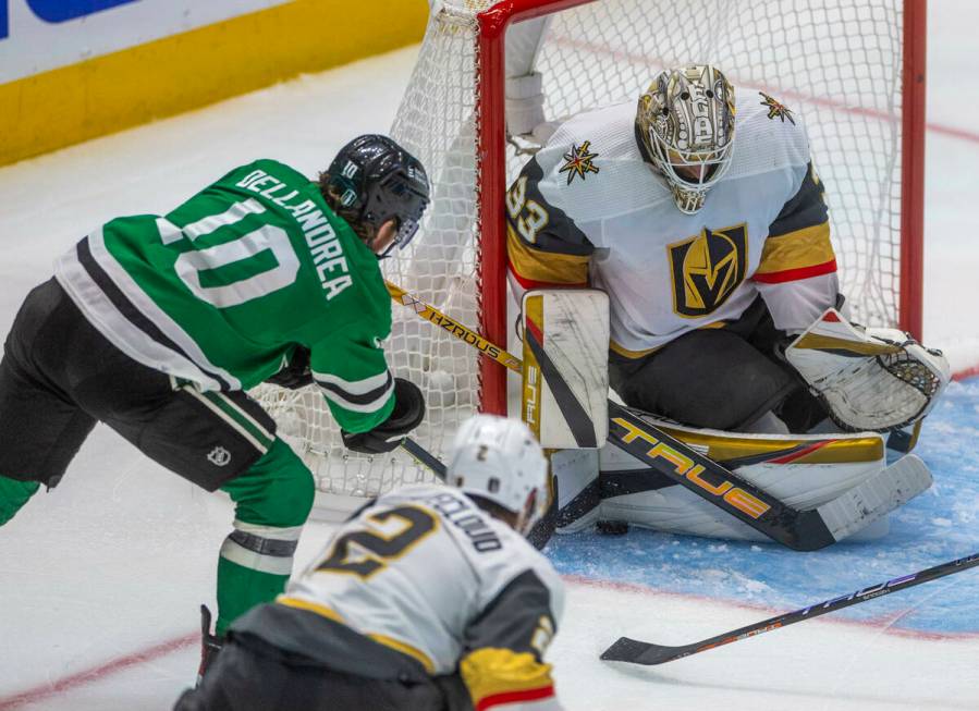 Golden Knights goaltender Adin Hill (33) traps a shot by Dallas Stars center Ty Dellandrea (10) ...