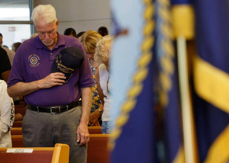 Purple Heart recipient U.S. Army veteran Dan Peterson of Henderson prays during a Memorial Day ...