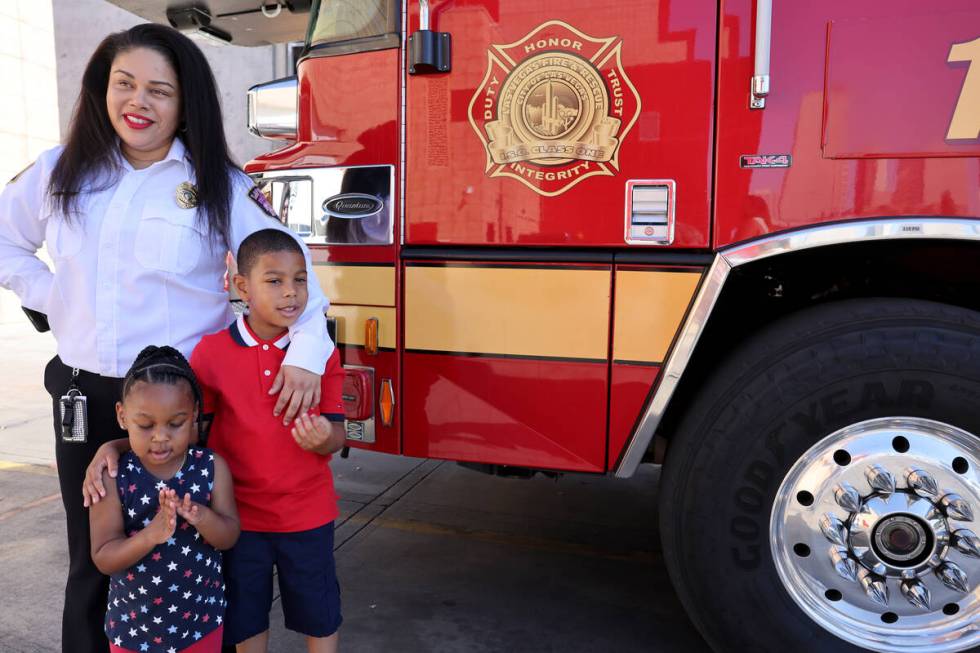 Reign Gray, 2, and Adonis Gray, 6 pose as their mother, Las Vegas Fire and Rescue Assistant Fir ...