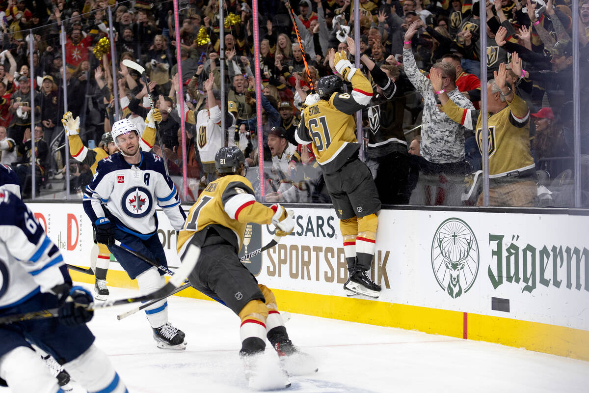 Golden Knights right wing Mark Stone (61) jumps into the boards in celebration after scoring du ...