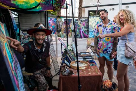 Jef Logan, left, shares his artwork with Tyler Albrektsen and Jordan Wood at the First Friday a ...