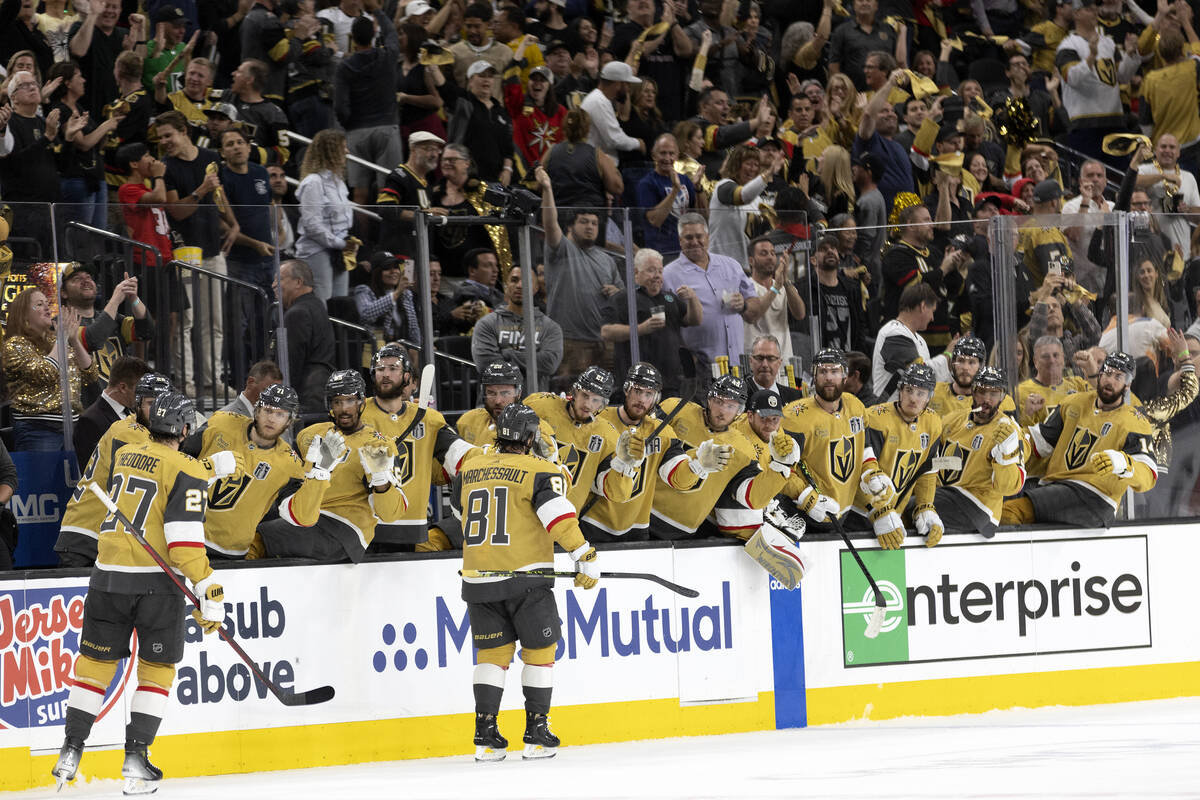 The Golden Knights bench congratulate right wing Jonathan Marchessault (81) on his goal during ...