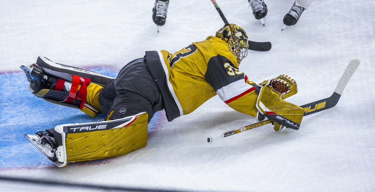 Golden Knights goaltender Adin Hill (33) dives onto a loose puck from the Florida Panthers duri ...