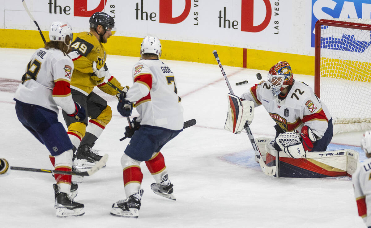 Golden Knights center Ivan Barbashev (49) watches a shot just misses past Florida Panthers goal ...