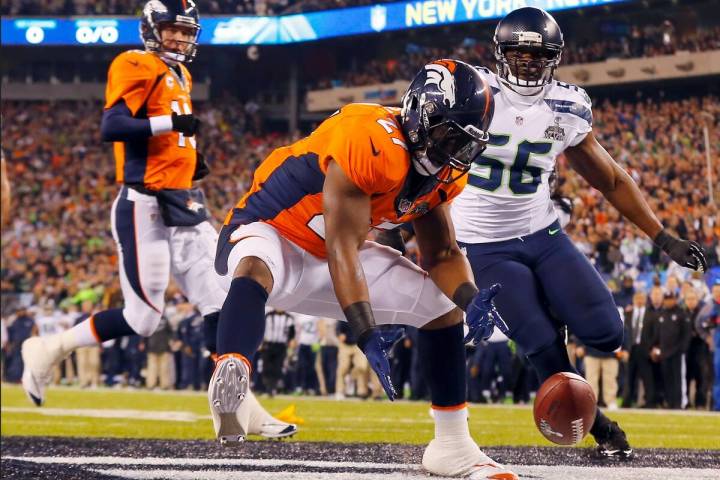 Denver Broncos' Knowshon Moreno reaches for a loose ball after the snap passed teammate Peyton ...