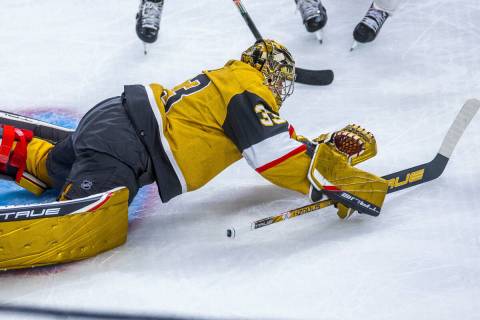 Golden Knights goaltender Adin Hill (33) dives onto a loose puck from the Florida Panthers duri ...