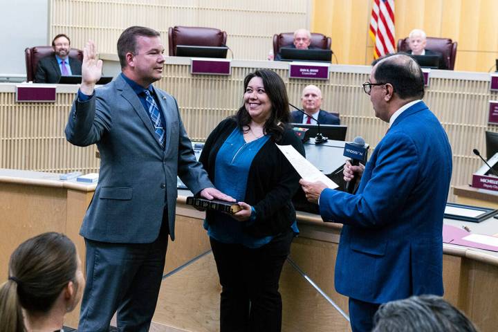 Jim Seebock is sworn in as Ward 1 City Councilman by City Clerk Jose Luis Valdez, right, as his ...