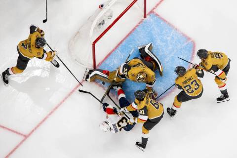 Golden Knights goaltender Adin Hill (33) saves the puck against Florida Panthers center Carter ...