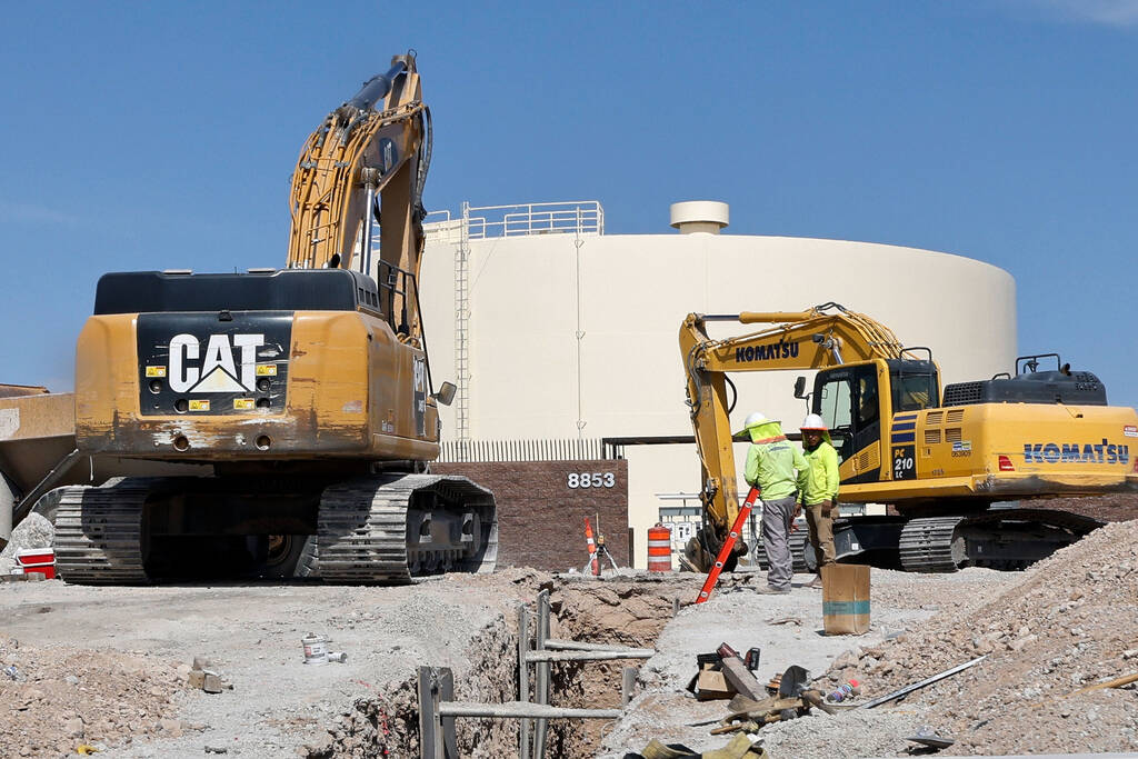Construction workers work around City of North Las Vegas’ water tank, Friday, June 9, 20 ...