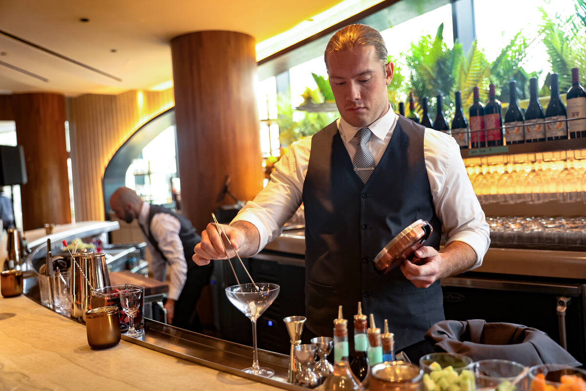 Bartender Nicolo Carlson creates the Berries & Bubbles cocktail at Ocean Prime, an upscale ...
