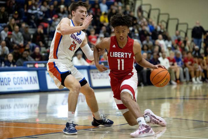 Liberty’s Dedan Thomas Jr. (11) dribbles around Bishop Gorman’s Ryder Elisaldez ( ...