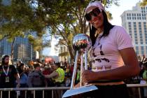 Las Vegas Aces forward A'ja Wilson holds up the WNBA Championship trophy during a parade Tuesda ...