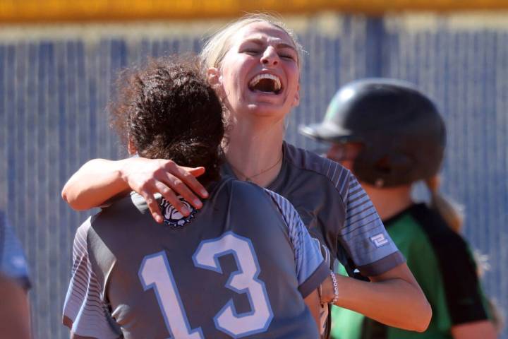 Centennial players, including pitcher Teagan Clemmons, right, and Keana Bell (13) celebrate bea ...