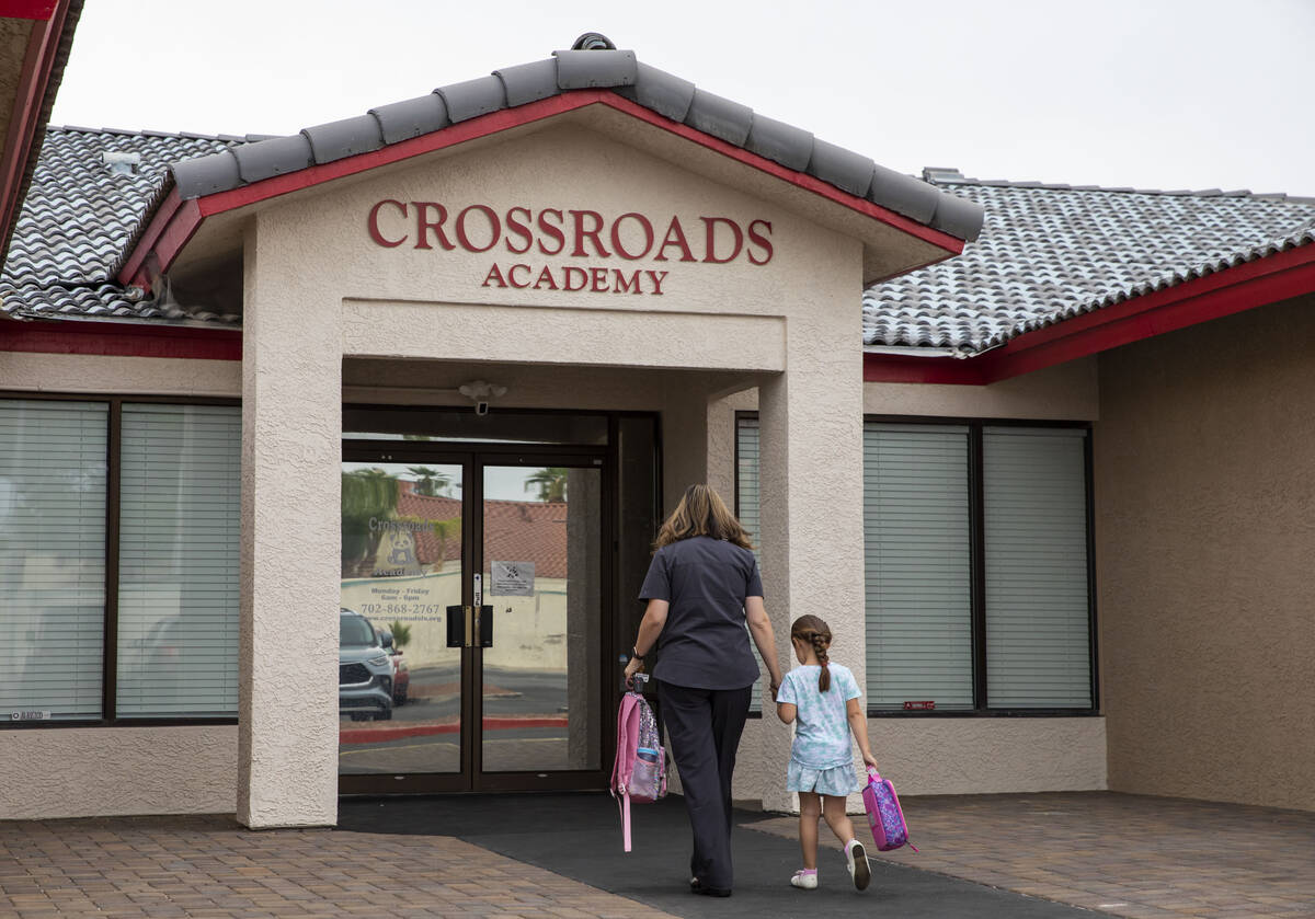 A girl is dropped off at the Crossroads Academy preschool on Wednesday, June 7, 2023, in Las Ve ...