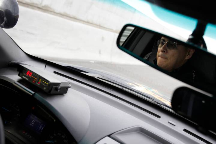 Trooper Loy Hixson of the Nevada Highway Patrol uses a radar, left, to check for speeders along ...