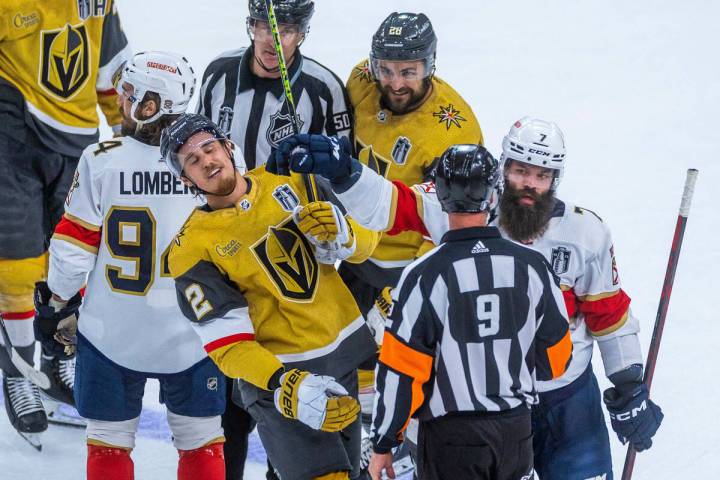 Golden Knights defenseman Zach Whitecloud (2) takes a glove to the face from Florida Panthers d ...