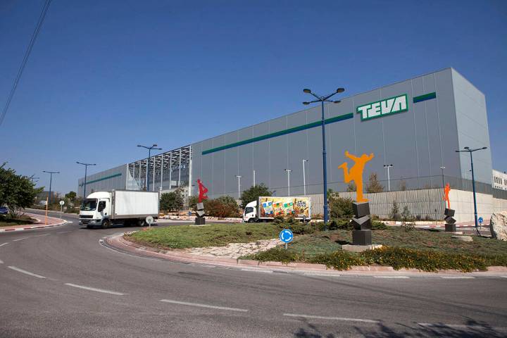 FILE - In this Wednesday, Oct. 16, 2013, file photo, trucks drive in front of Teva Pharmaceutic ...