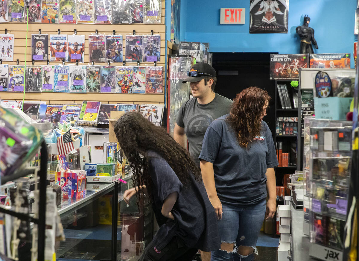 Customers peruse through a vast collection of comics at Action Comics and Games along the Bould ...