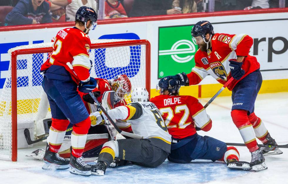 Golden Knights right wing Jonathan Marchessault (81) gets caught in the scrum as Florida Panthe ...