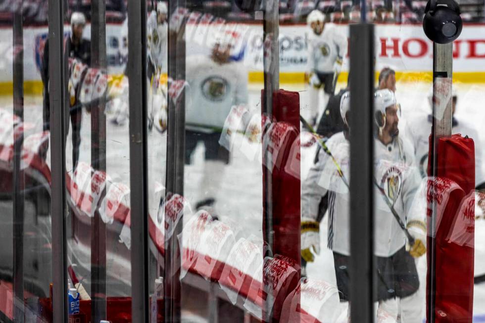 Golden Knights players skate on the ice as towels are hung on the seats during the morning skat ...