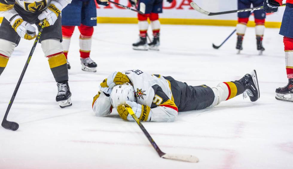 Golden Knights center Jack Eichel (9) lies injured on the ice against the Florida Pantghers in ...