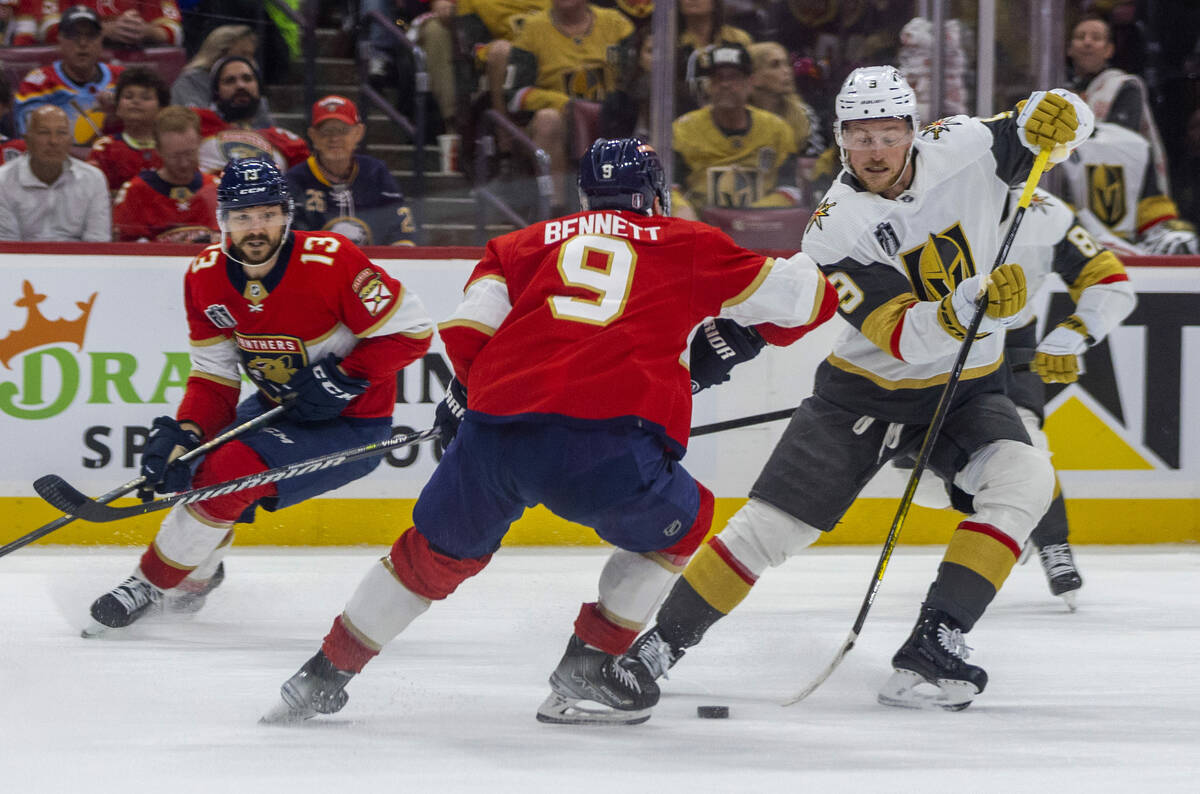 Golden Knights center Jack Eichel (9) maneuvers around Florida Panthers center Sam Bennett (9) ...