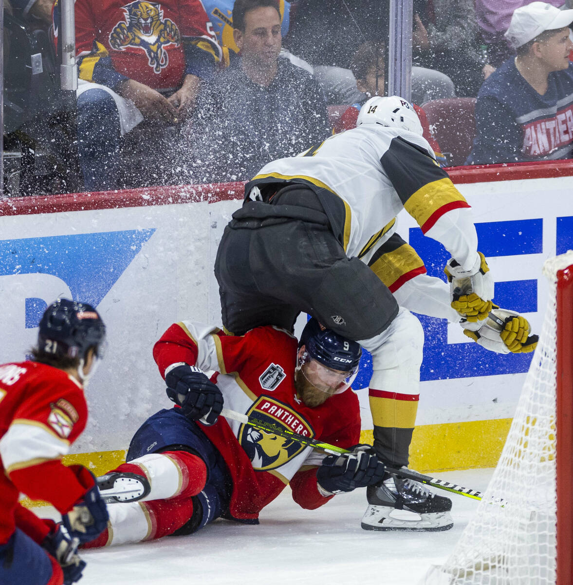 Golden Knights defenseman Nicolas Hague (14) takes down Florida Panthers center Sam Bennett (9) ...