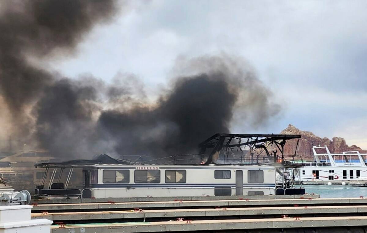 This photo shows smoke rising from a fire on Friday, June 2, 2023, at Wahweap Marina on Lake Po ...