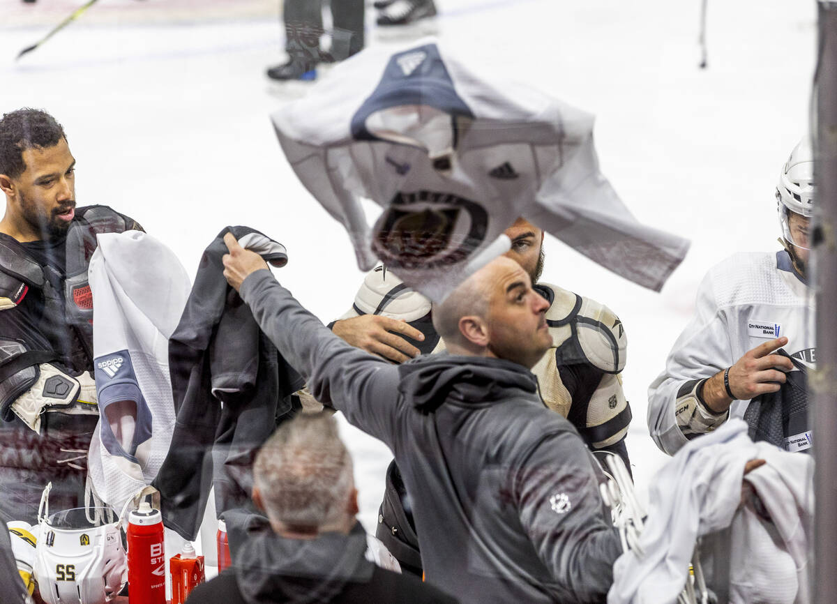 Golden Knights left wing William Carrier (28) tosses a practice jersey to the bench as players ...