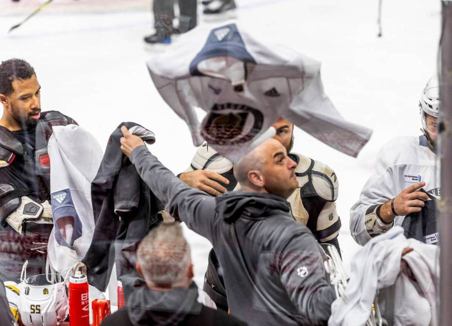 Golden Knights left wing William Carrier (28) tosses a practice jersey to the bench as players ...