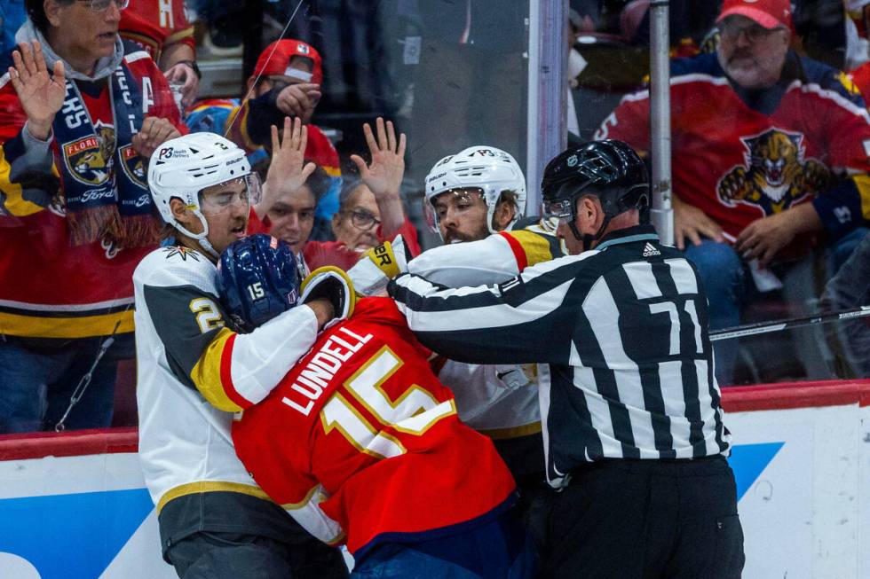 Golden Knights defenseman Zach Whitecloud (2) fights with Florida Panthers center Anton Lundell ...