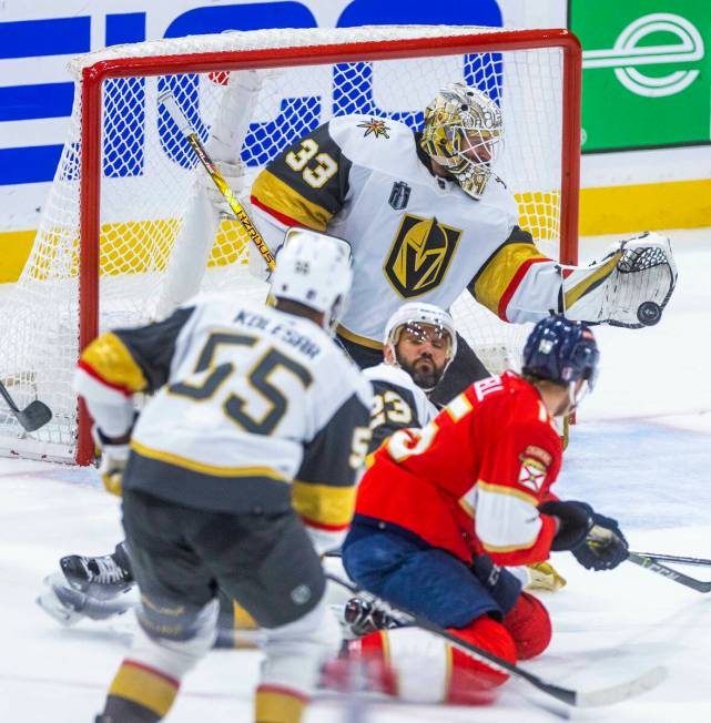 Golden Knights goaltender Adin Hill (33) makes another save against Florida Panthers defenseman ...
