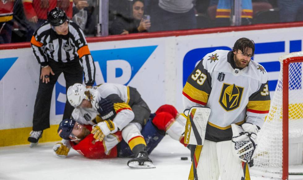 Golden Knights goaltender Adin Hill (33) looks dismayed as his teammates and the Florida Panthe ...