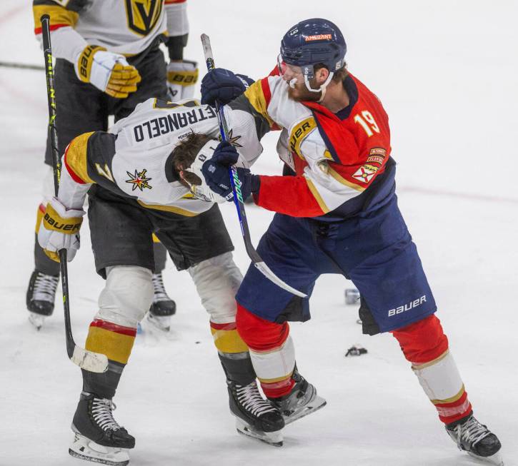 Golden Knights defenseman Alex Pietrangelo (7) gets a stick to the back of the neck nearly losi ...