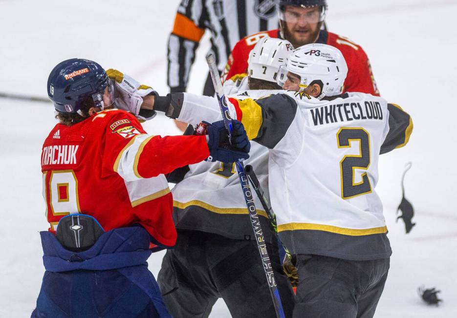 Florida Panthers left wing Matthew Tkachuk (19) takes a glove to the face from Golden Knights d ...