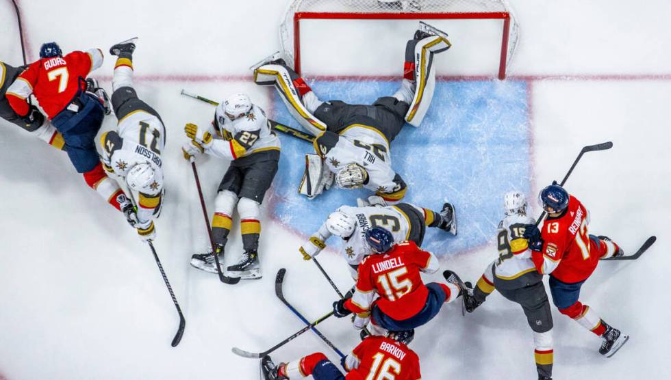 Golden Knights and Florida Panthers players are sprawled on the ice after a late shot attempt i ...