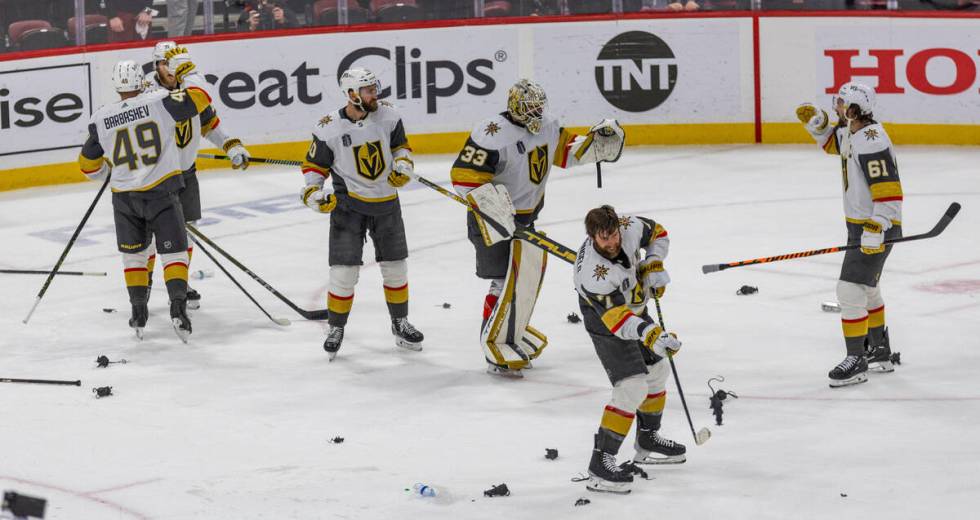 Golden Knights defenseman Alex Pietrangelo (7) slaps away a rat as he and teammates begin to ce ...