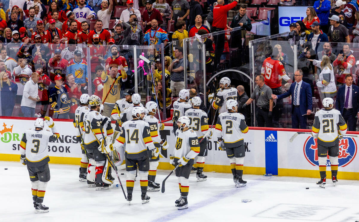 Golden Knights players depart the ice as they look to avoid rats and bottles being thrown down ...