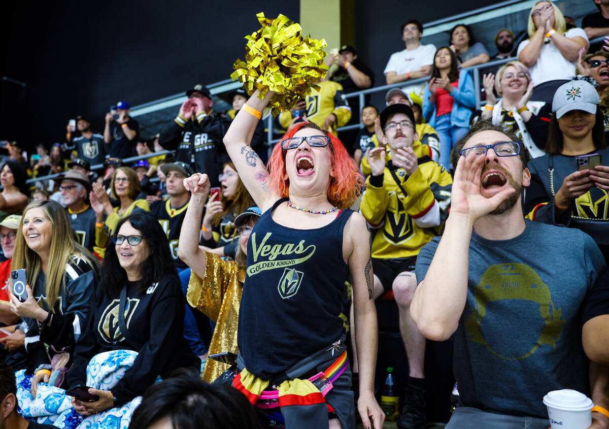 Fans Lizz Harris, left, and her boyfriend Justin Farmer, right, cheer the Golden Knights at pra ...