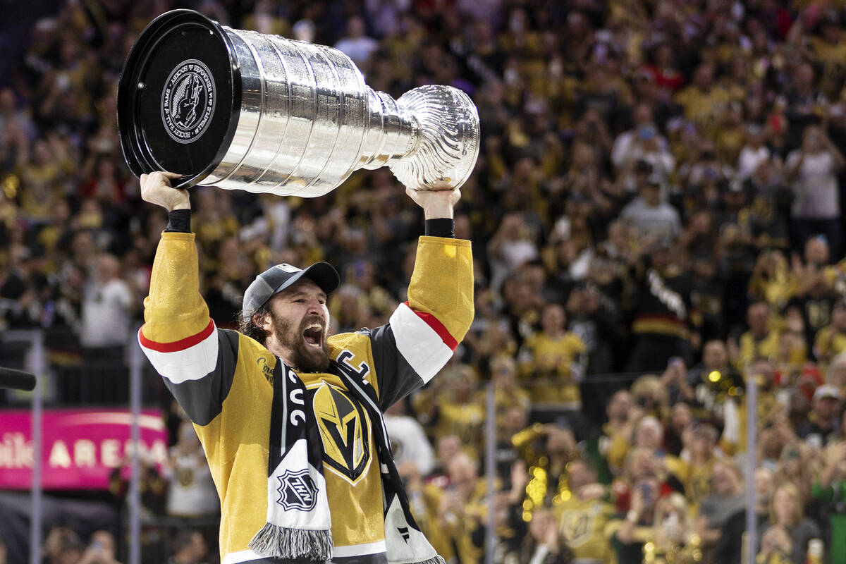 Golden Knights right wing and captain Mark Stone holds up the Stanley Cup after winning Game 5 ...