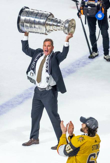 Golden Knights head coach Bruce Cassidy hoists the Stanley Cup after their 9-3 win over the Flo ...