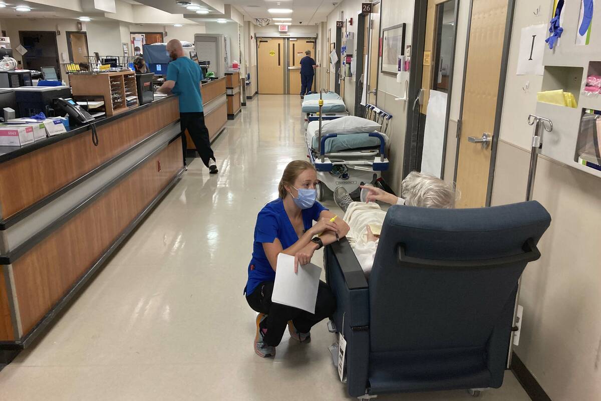 FILE - In this Aug. 20, 2021, file photo, a nurse talks to a patient in the emergency room at S ...