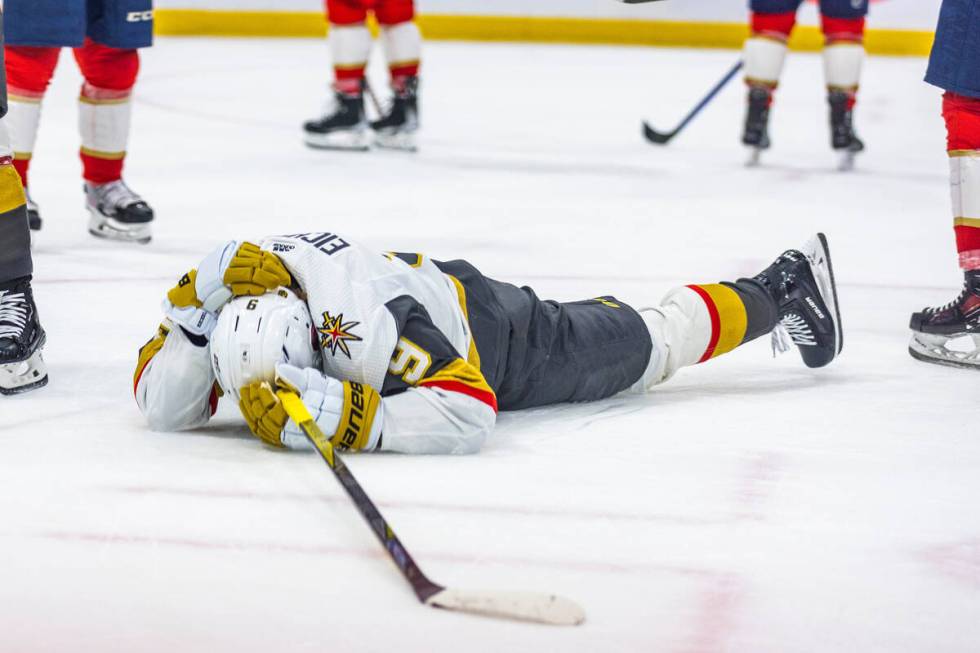 Golden Knights center Jack Eichel (9) lies injured on the ice against the Florida Pantghers in ...