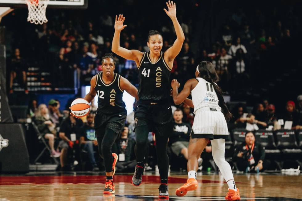 Aces center Kiah Stokes (41) throws her hands up as Chicago Sky guard Dana Evans (11) tries to ...