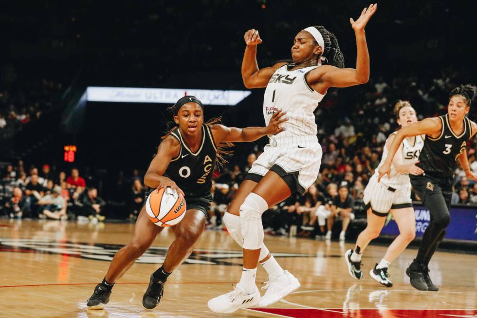 Aces guard Jackie Young (0) pushes off Chicago Sky center/forward Elizabeth Williams (1) in an ...