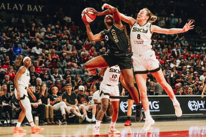 Aces guard Jackie Young (0) grabs the ball for a rebound as Chicago Sky forward Alanna Smith at ...