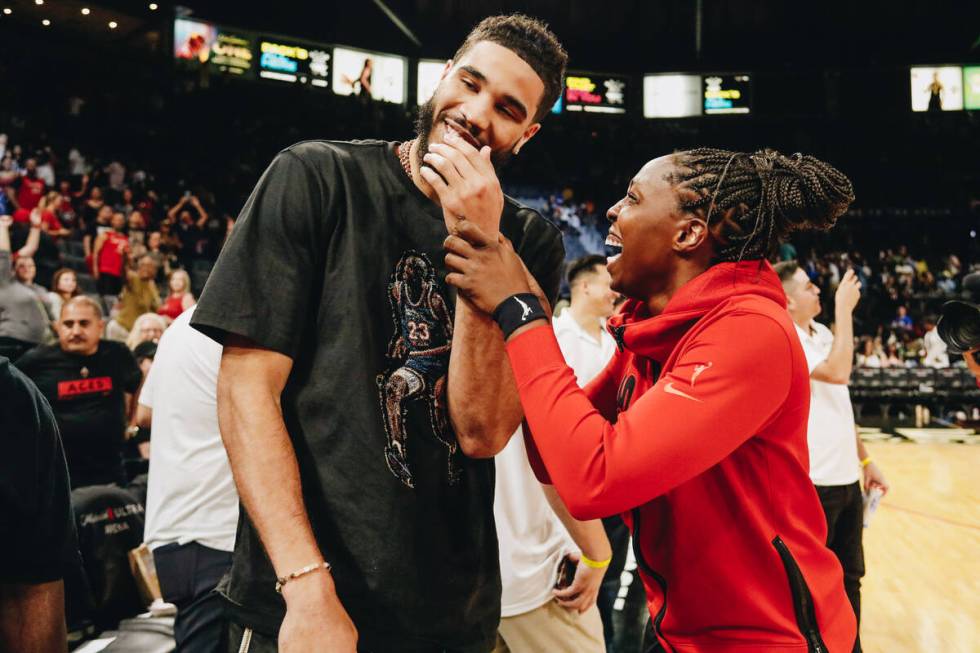 Celtics small forward Jayson Tatum (left) laughs with Aces guard Chelsea Gray following the Ace ...