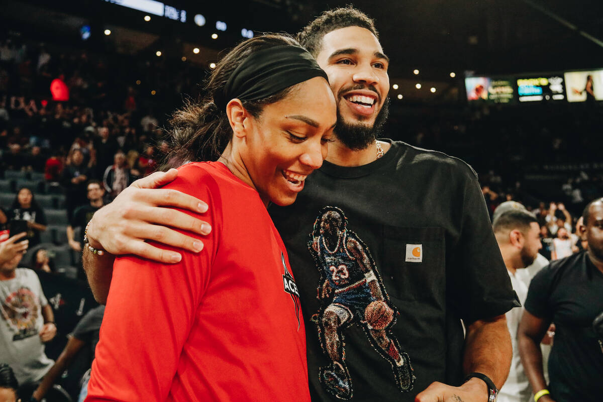 Aces center A’ja Wilson (left) smiles as Celtics small forward Jayson Tatum hugs her fol ...