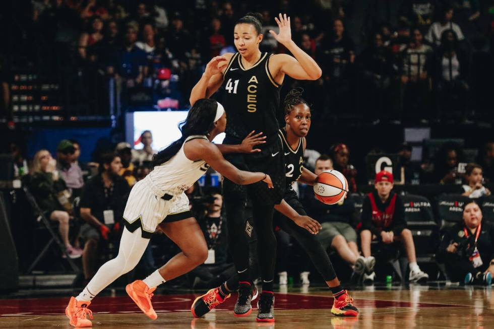 Aces center Kiah Stokes (41) puts her hands up as Chicago Sky guard Dana Evans (11) tries to ge ...