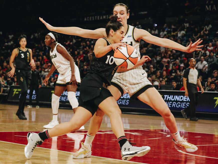 Aces guard Kelsey Plum (10) drives the ball to the hoop as Chicago Sky forward Alanna Smith (8) ...